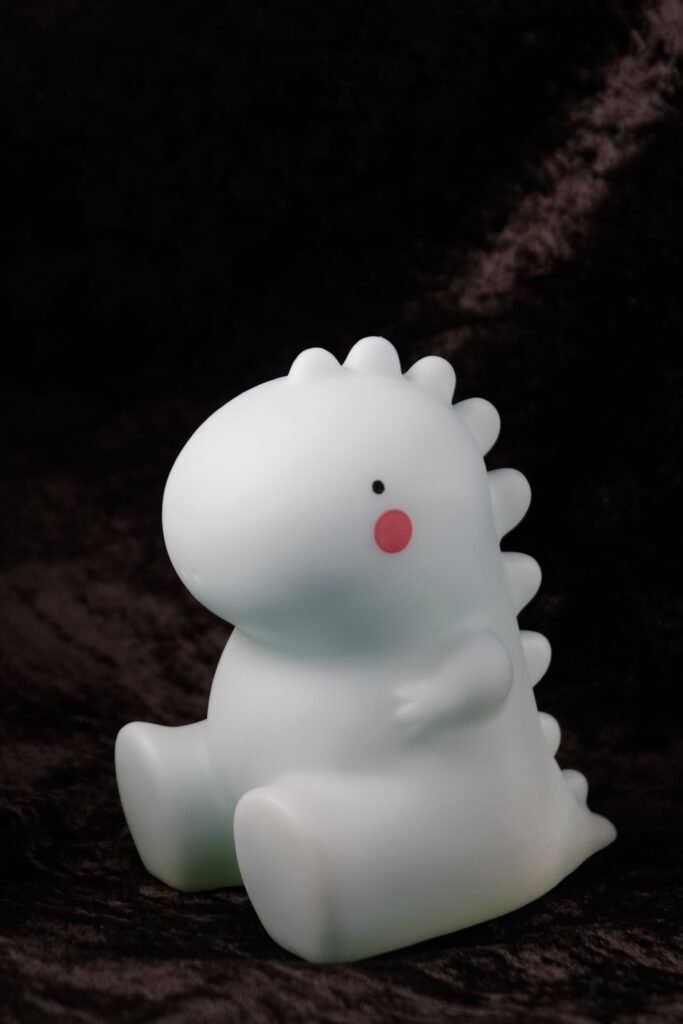 Adorable dinosaur toy with a smooth finish and vibrant cheeks, perfect for decoration.